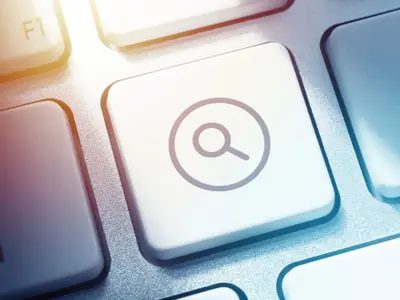 A keyboard key with a magnifying glass icon on it.